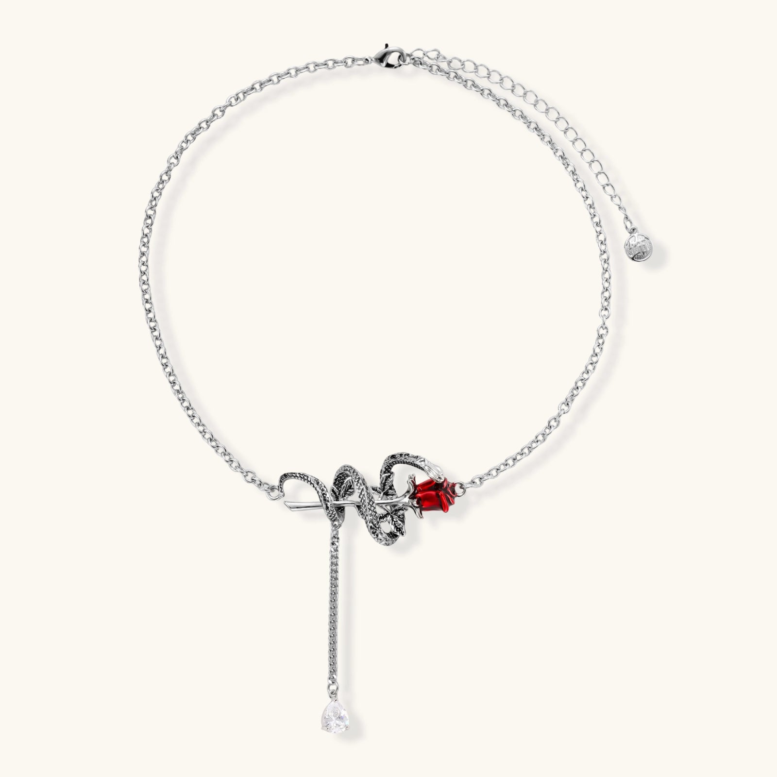 Detailed eco-brass serpent pendant necklace with red zirconia stone and crystal drop tassel on adjustable chain