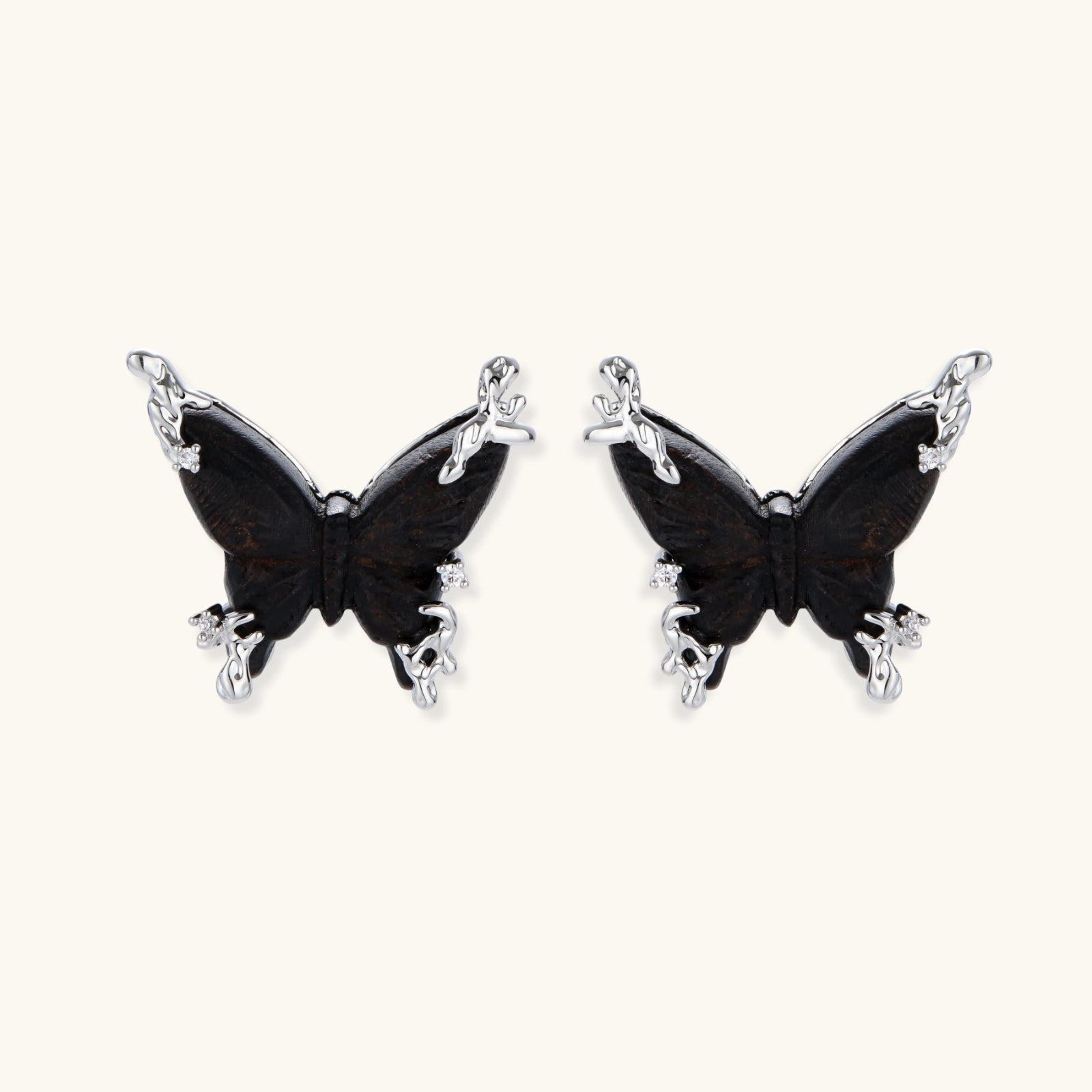 Wooden butterfly earrings with silver chain details in light and dark wood variants on white background
