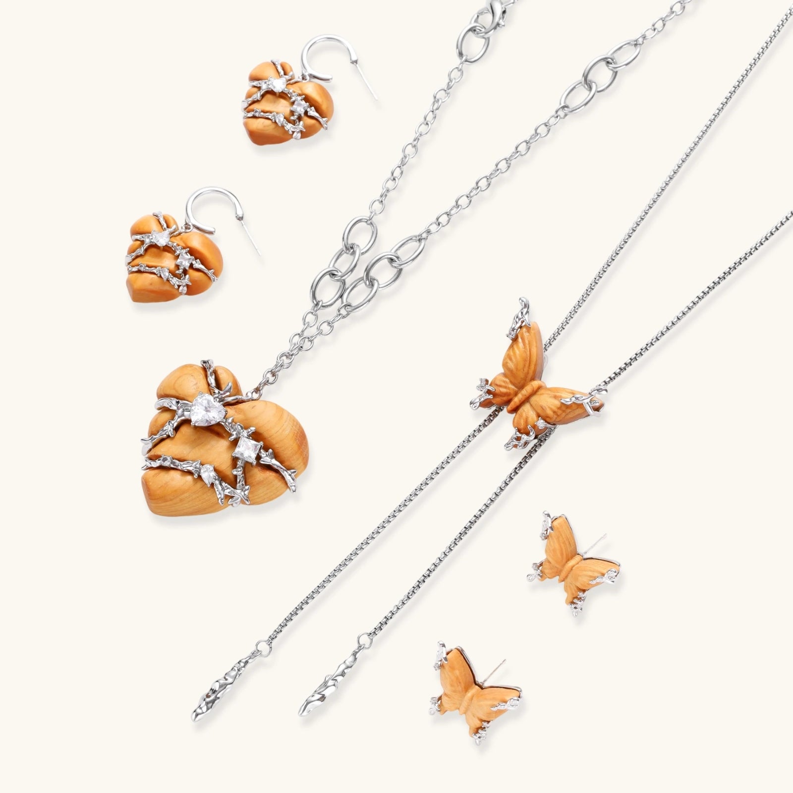 Heart-shaped eco-brass and wood jewelry set with silver wire detailing and crystal accents on cream background.