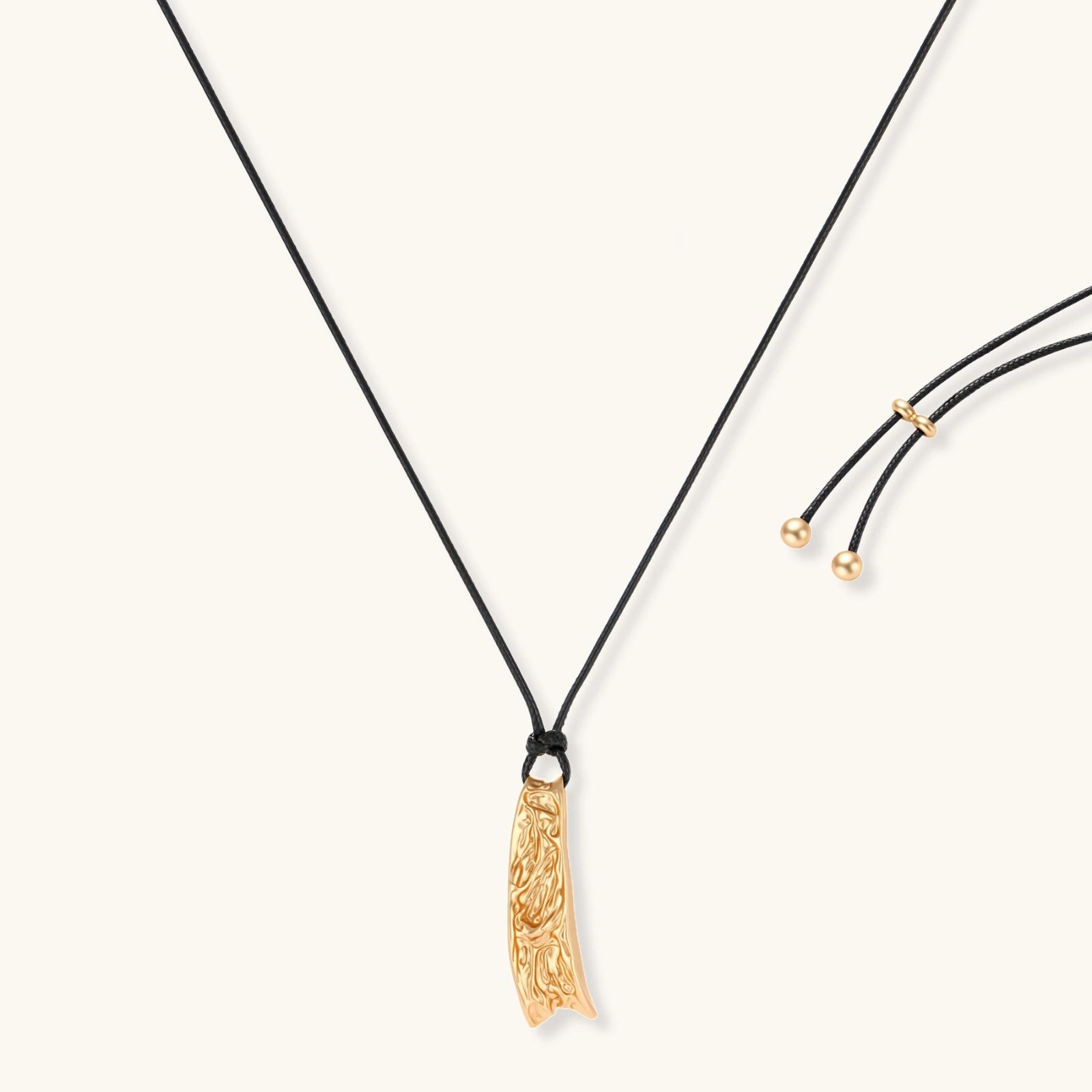 Curved textured pendant necklace on black adjustable cord with metallic finish in gold or silver