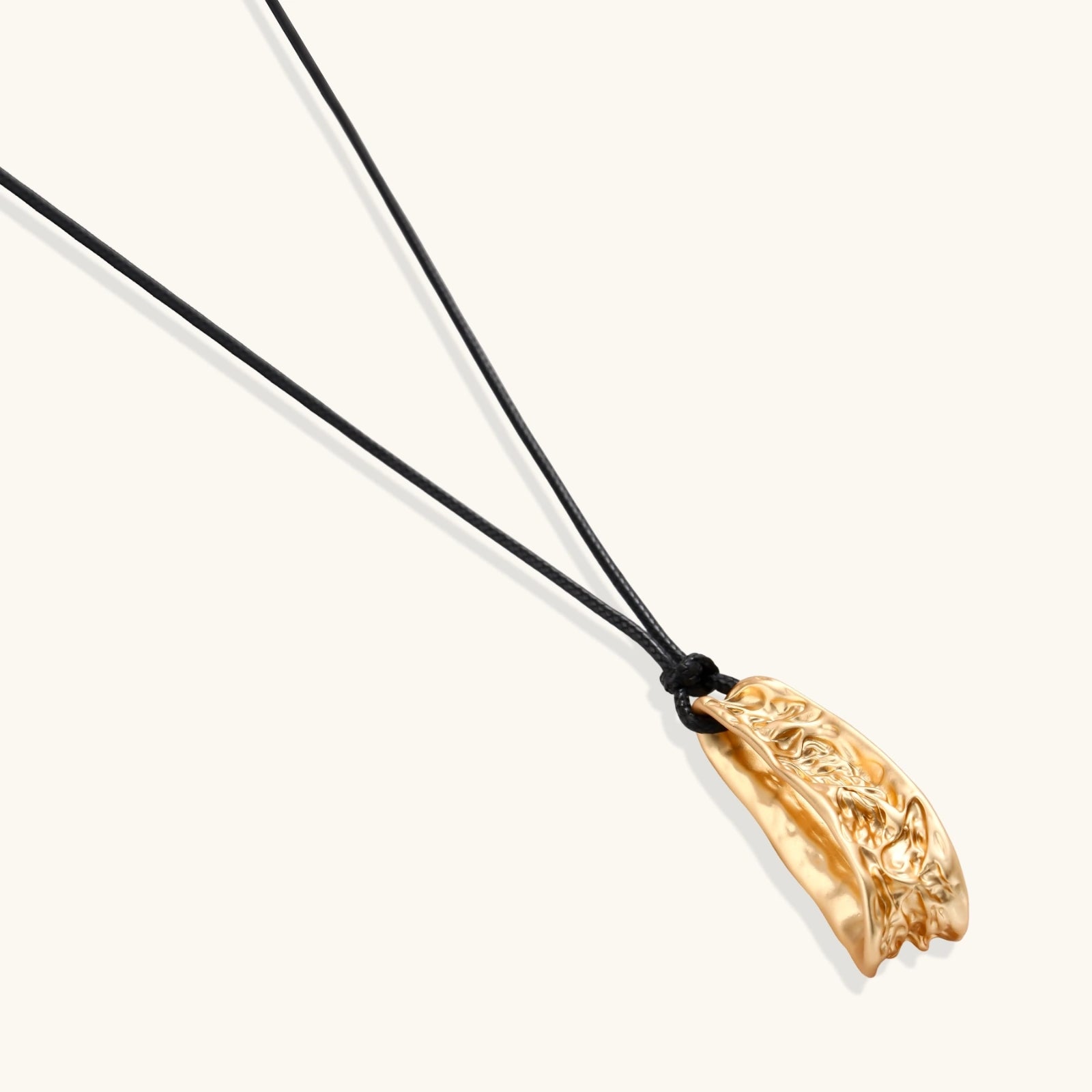 Curved textured pendant necklace on black adjustable cord with metallic finish in gold or silver