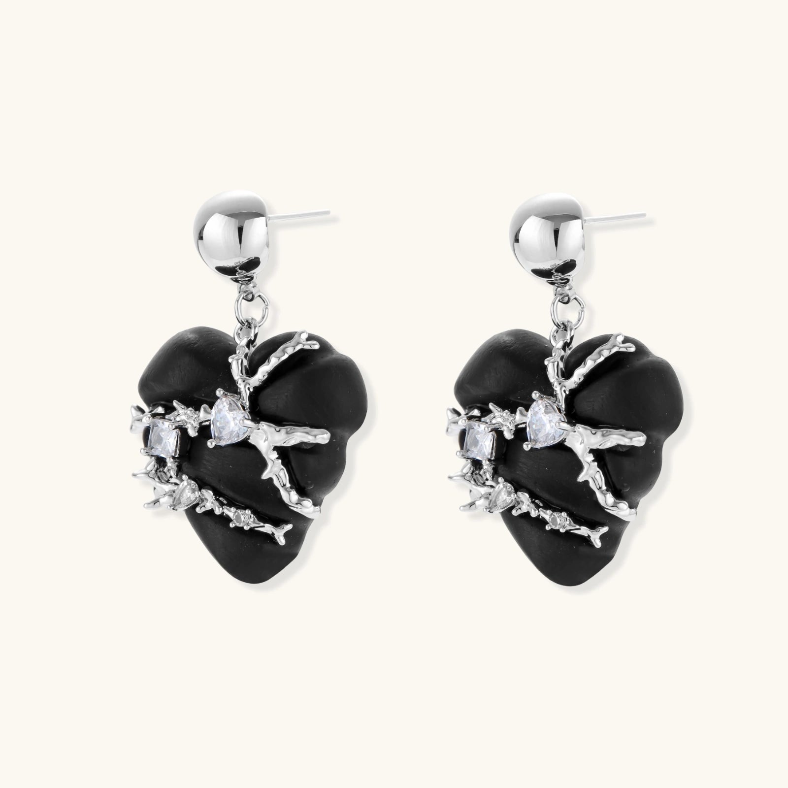 Black heart-shaped wood earrings with decorative silver chains and crystal accents hanging from silver ball studs